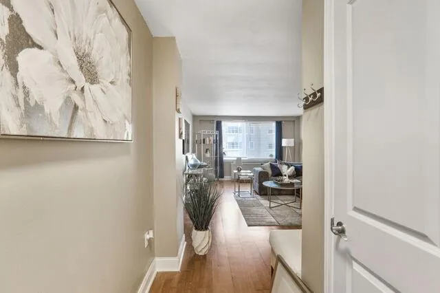 Hall with wood finished floors and baseboards