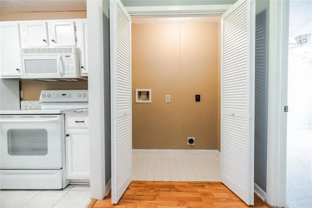 Hallway laundry area has room for a side x side washer and dryer.