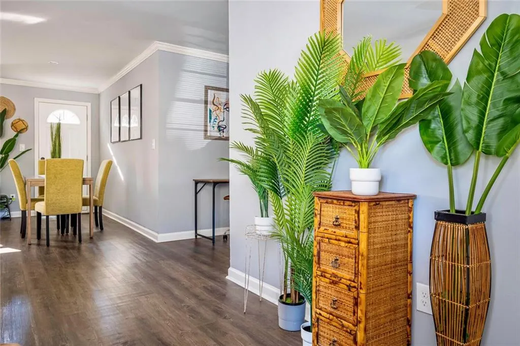 Sitting room with ornamental molding and wood finished floors
