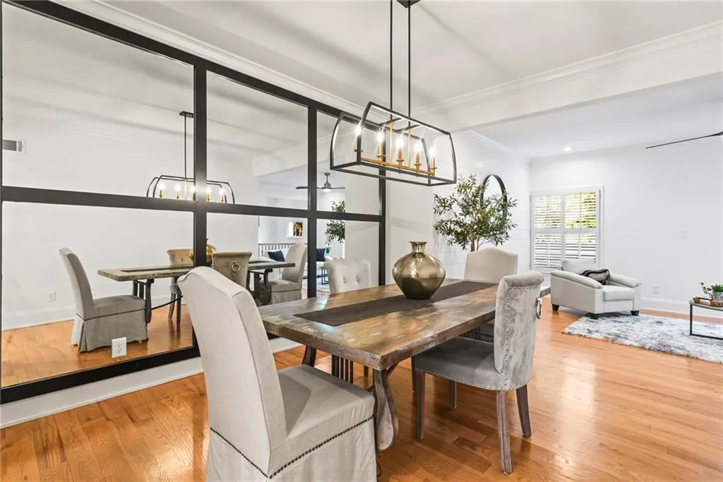 Dining space featuring a chandelier, ornamental molding, and hardwood / wood-style flooring