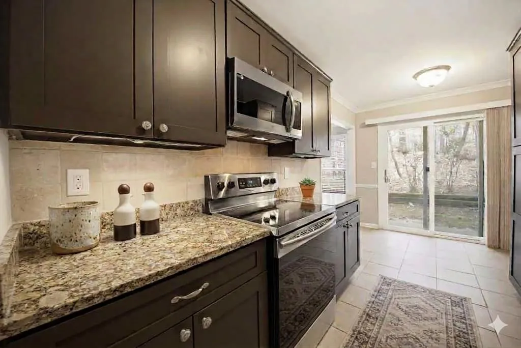 The kitchen features granite countertops and stainless-steel appliances