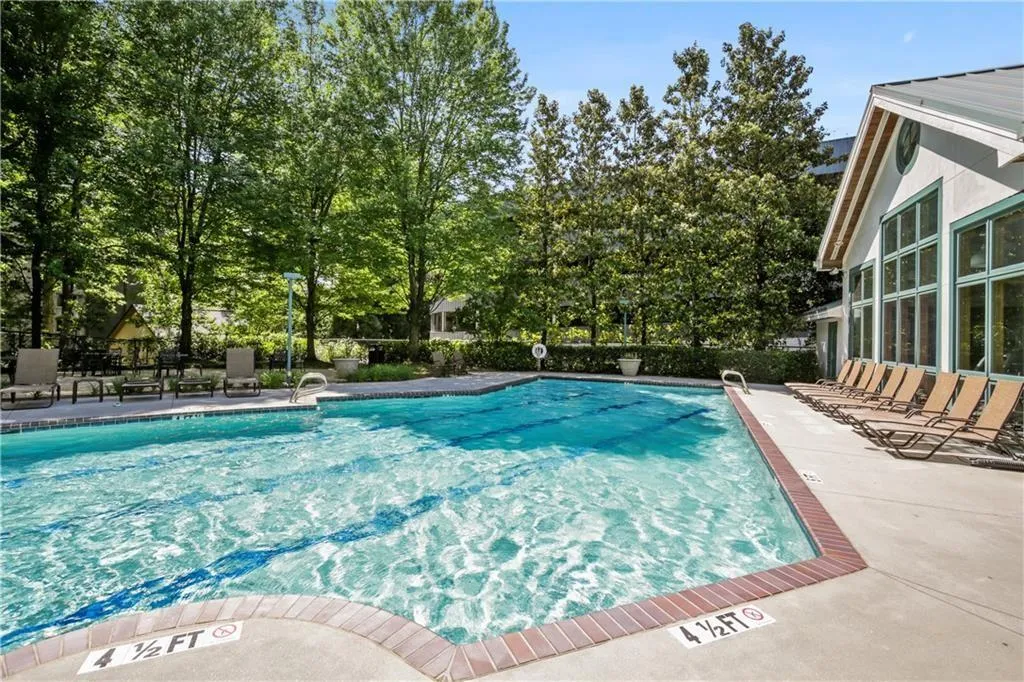 Resort-style swimming pool featuring crystal-clear water, brick decking, and integrated lane markers