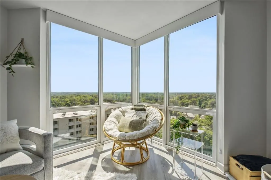 Corner window bank with floor-to-ceiling glass panels and wood-finish flooring