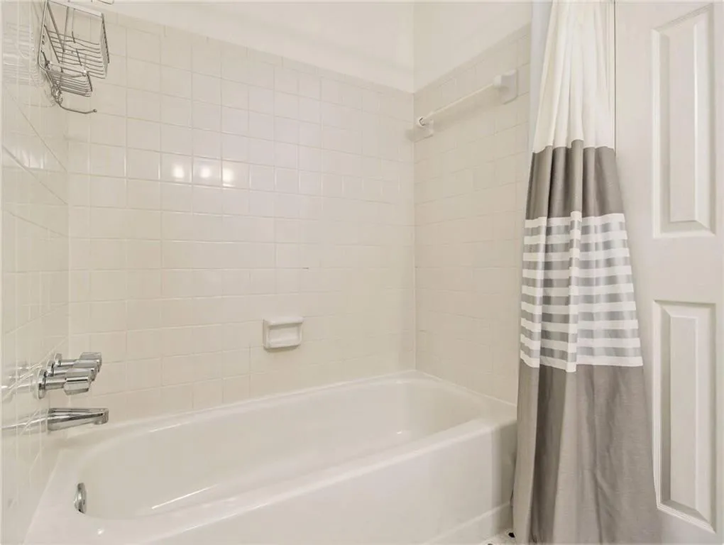 White tiled shower surround with a built-in soap dish