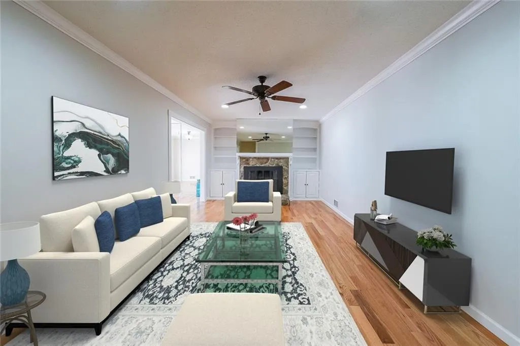 Virtually Staged Living room with a premium fireplace, light hardwood / wood-style flooring, ceiling fan, crown molding, and built in shelves