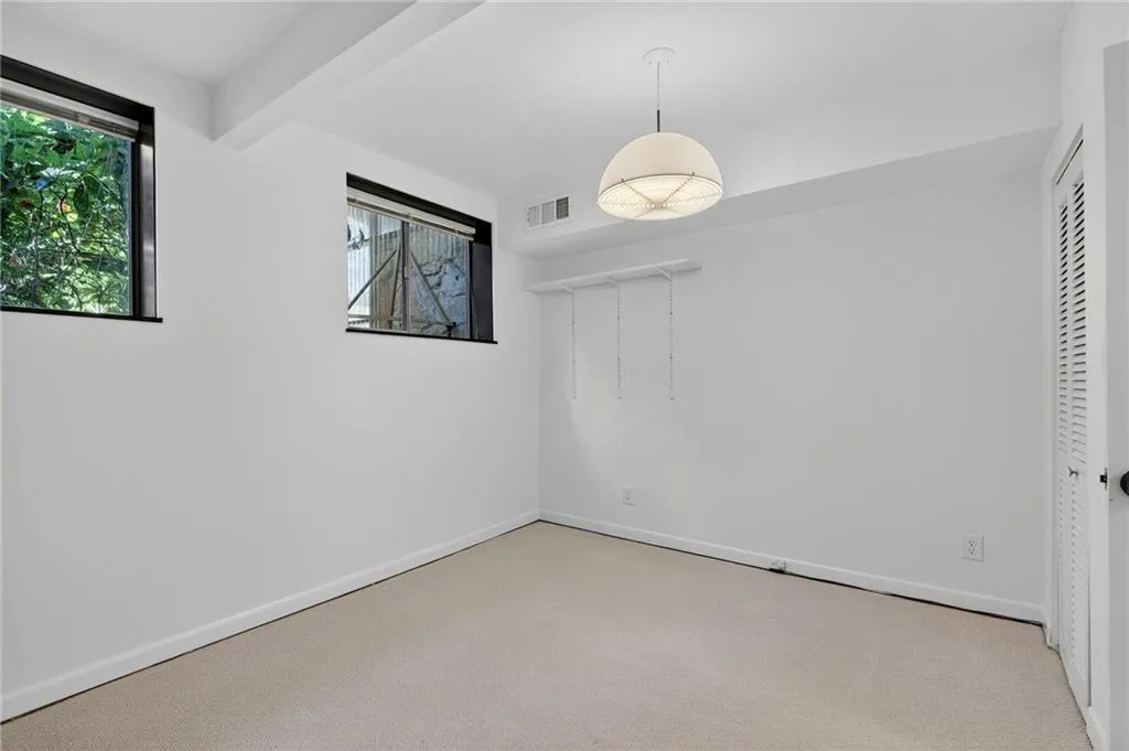 Unfurnished bedroom with carpet and a closet