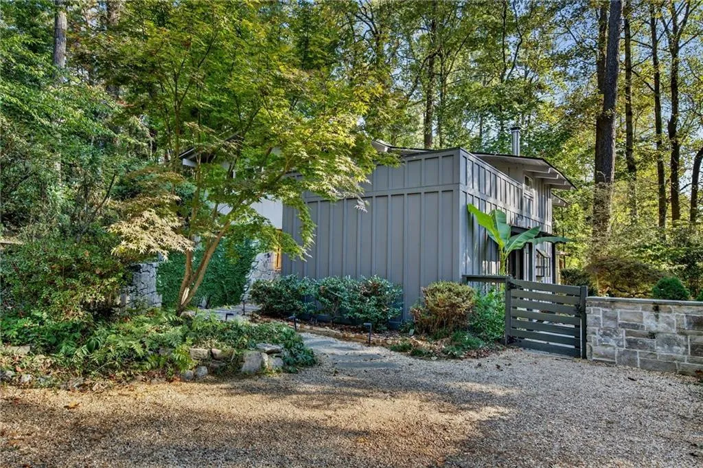 View of yard with a gate and view of wooded area