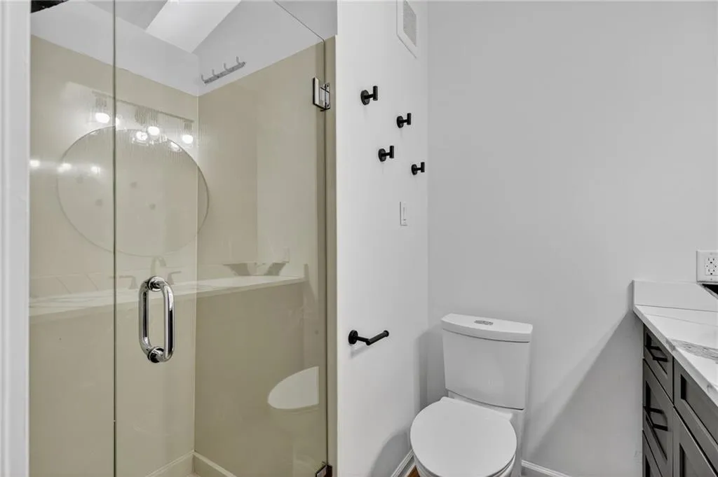 Bathroom with vanity and a stall shower