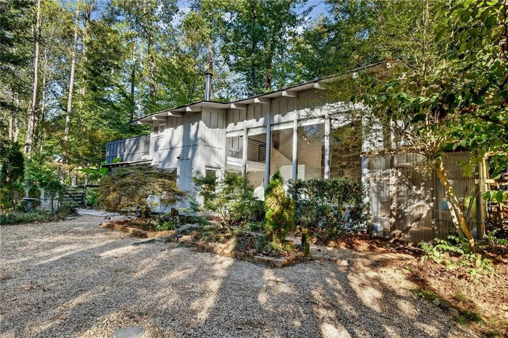 View of property exterior featuring view of scattered trees
