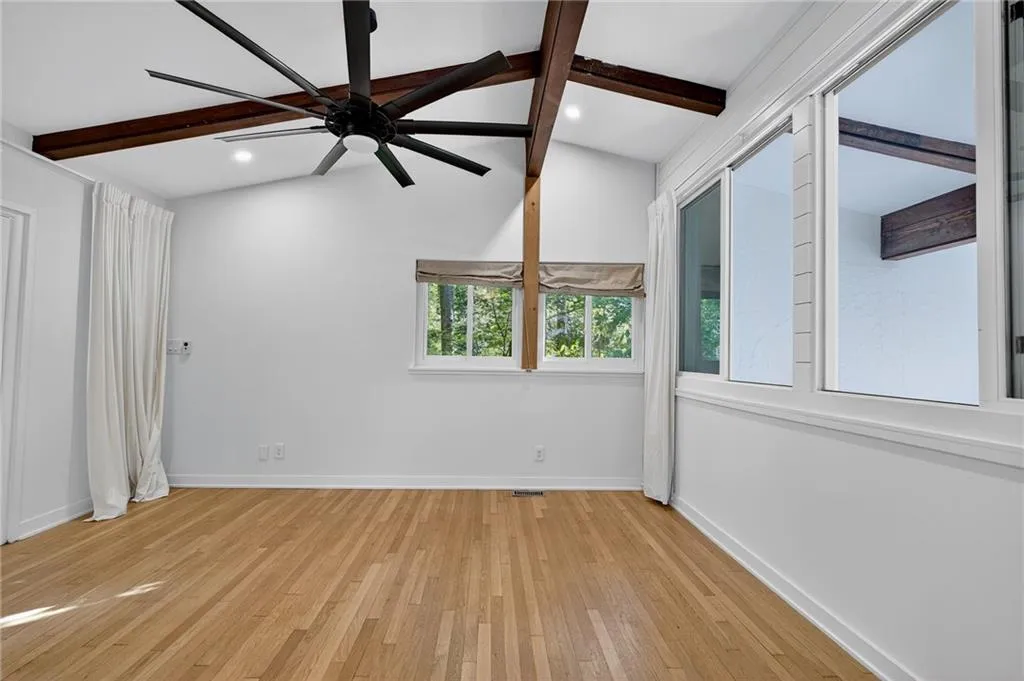 Unfurnished room with light wood-style floors and a ceiling fan