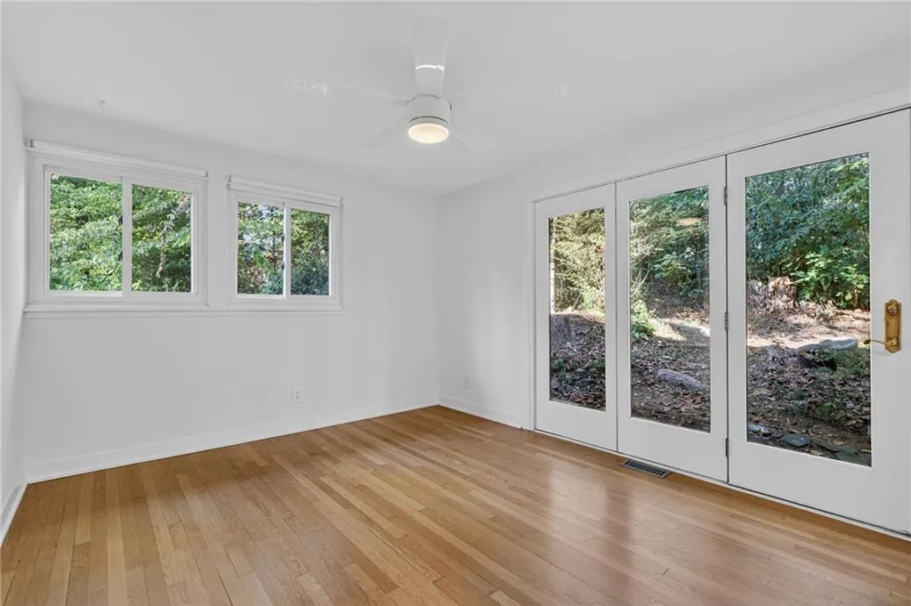 Spare room with light wood-type flooring and a ceiling fan