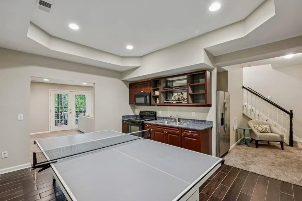 The Daylight Terrace Level is an Entertainer's Dream featuring a Bar with Kitchen, Movie Theater Space, Room for a Pool Table and Games, plus a Bedroom, Flex Space, and Full Bathroom.