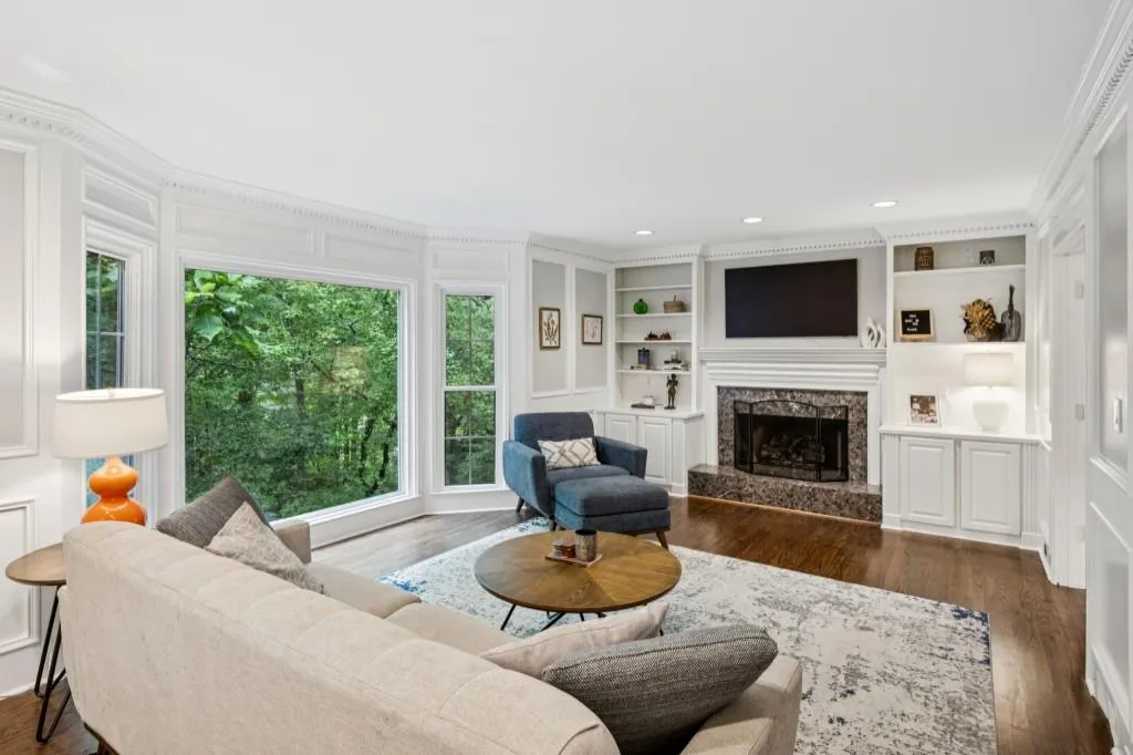 The Family Room features a Fireplace framed by Custom Built-Ins and a Wet Bar with Sink and Cabinets.