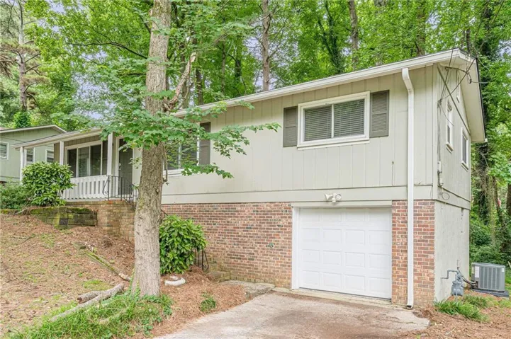 Split-level residence featuring a brick foundation and siding exterior