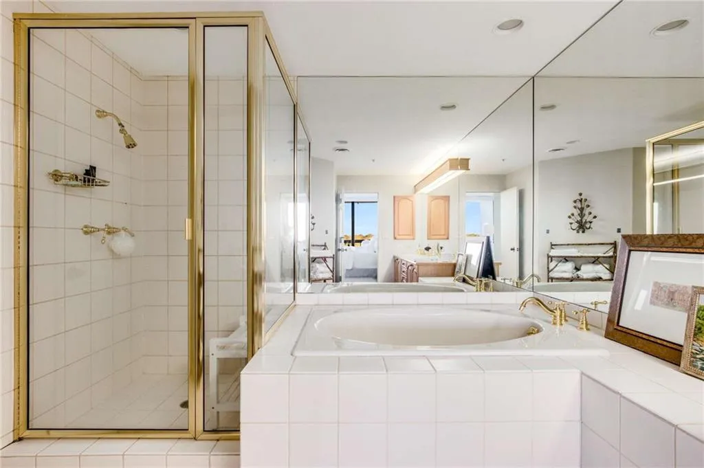 Ensuite bathroom with a shower stall, a garden tub, and vanity