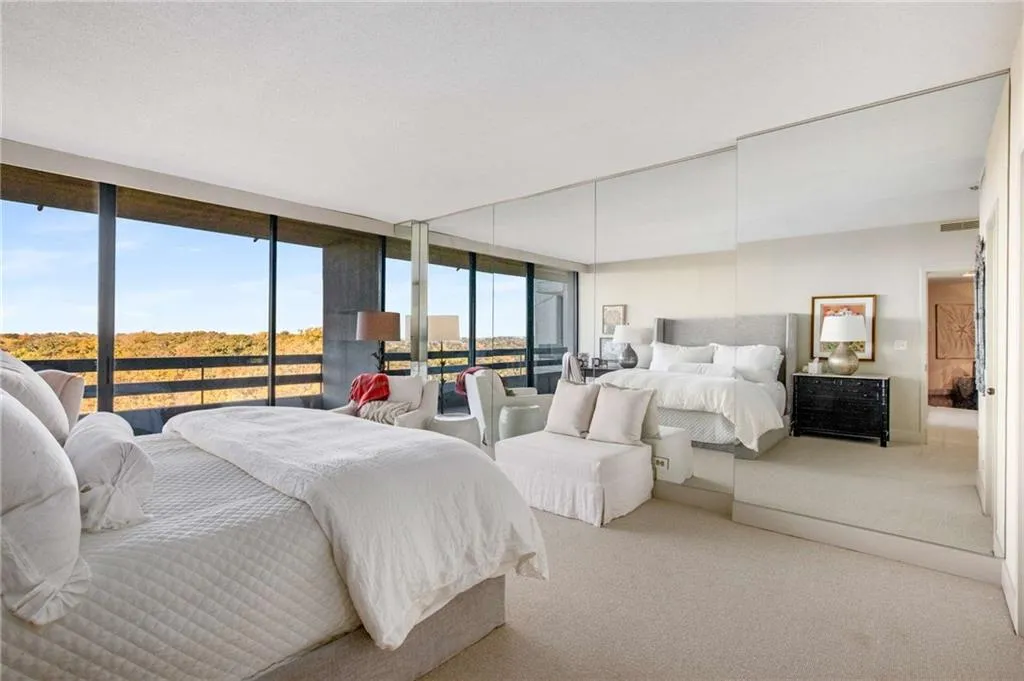 Bedroom with carpet, access to exterior, and expansive windows