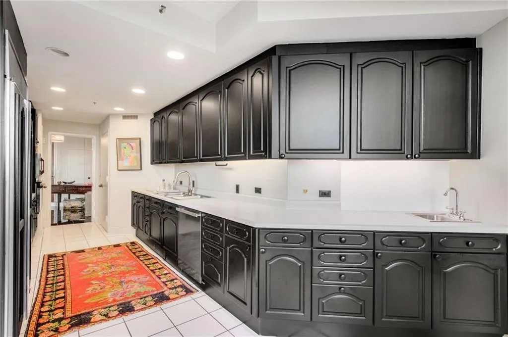 Laundry room featuring light tile patterned floors and recessed lighting