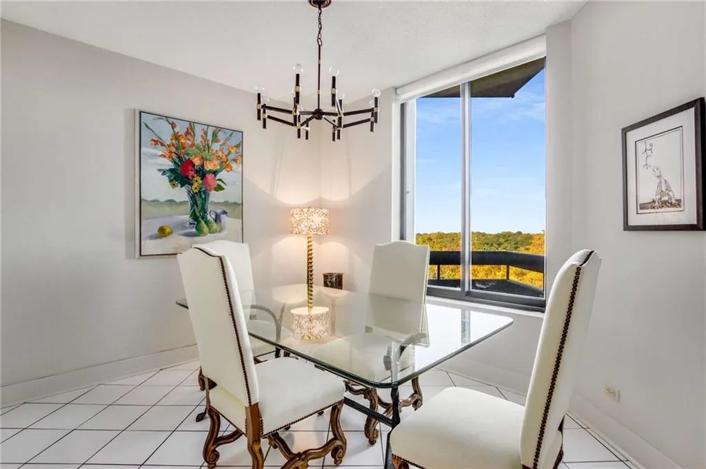 Dining area featuring hanging lights and light tile patterned floors
