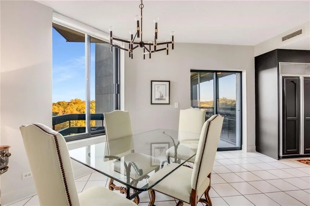 Dining area with light tile patterned floors and suspended lighting