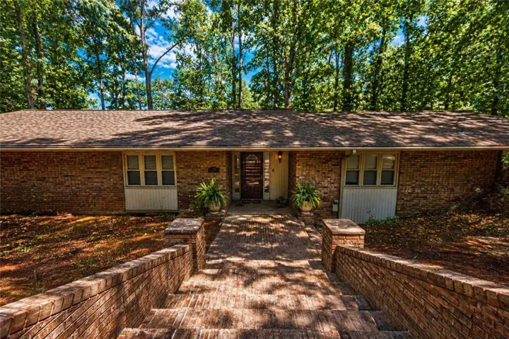 Brick exterior home with a gabled roofline