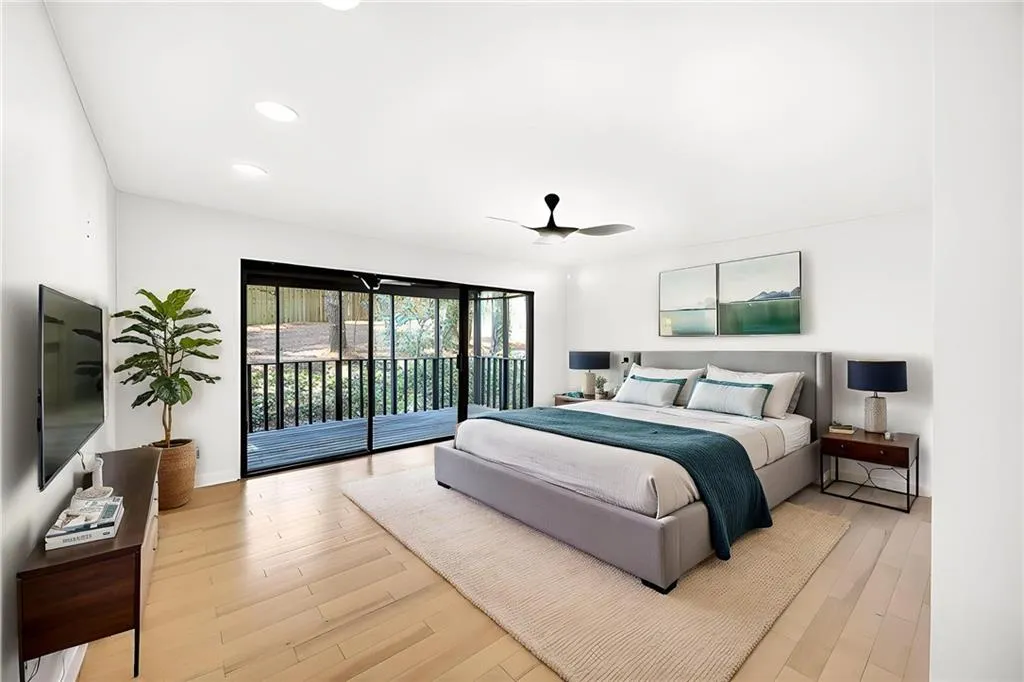 Primary bedroom with private covered and screened patio
