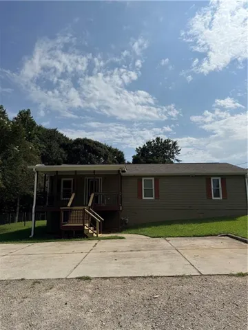 Exterior featuring horizontal siding, a covered porch with railings, and a concrete driveway