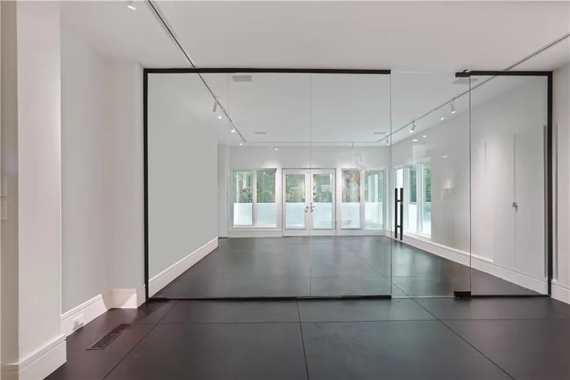 Large room with French doors onto balcony - could be family room, gym, bedroom Large room with French doors onto balcony - could be family room, gym, bedroom