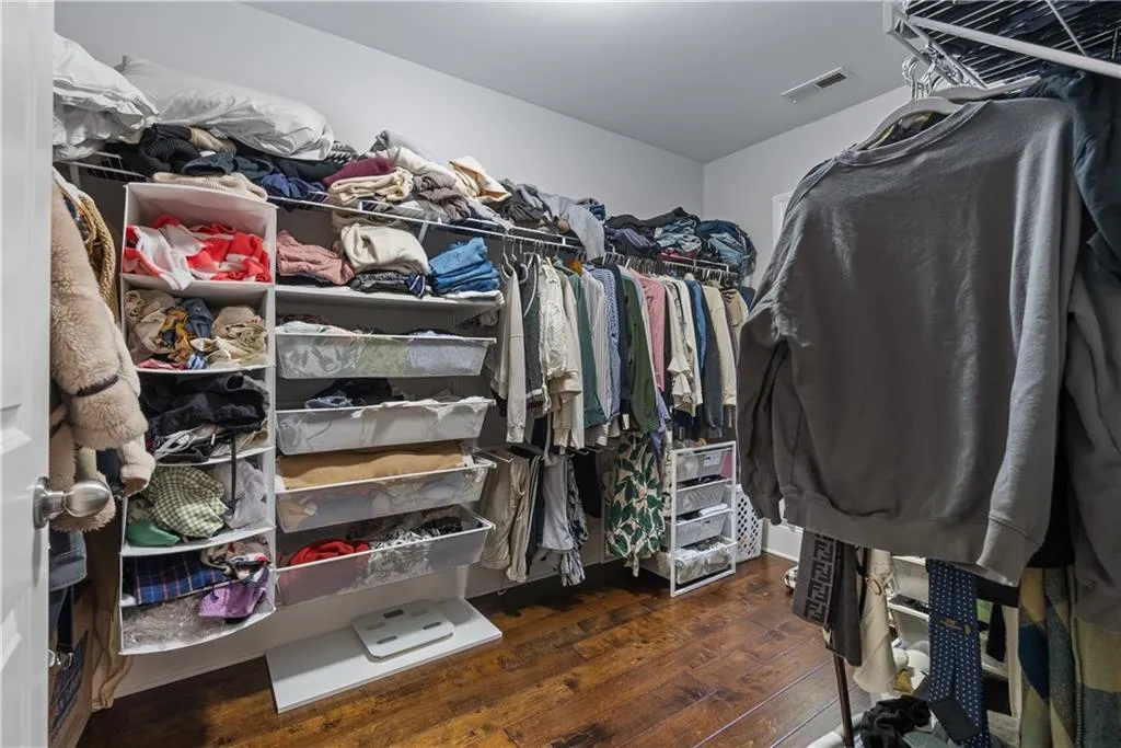 Spacious closet featuring visible vents and wood-type flooring