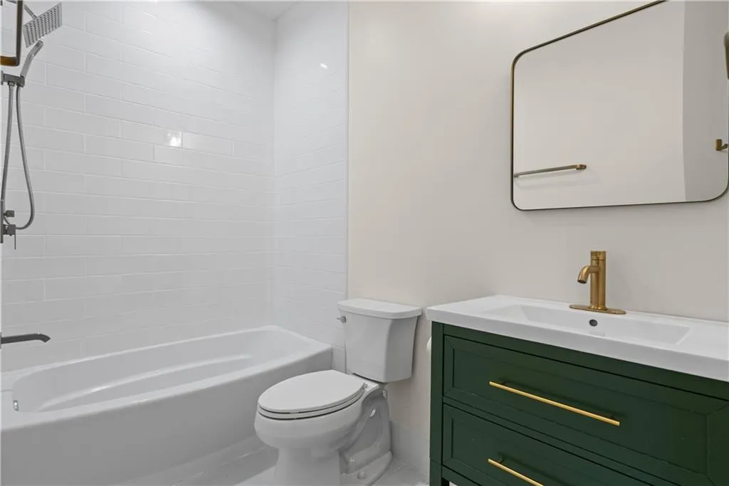 Full bathroom with vanity, toilet, and shower / bath combination