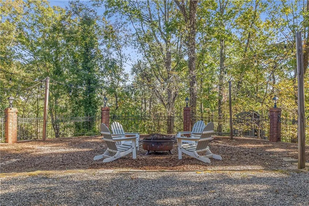 Large firepit area with cafe lights is dreamy in the evening! You'll feel like you're in your own mountain retreat!