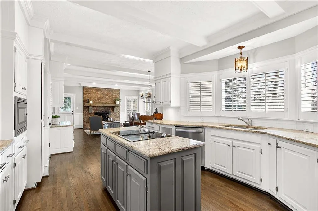 Light & bright kitchen features painted solid wood cabinetry, granite countertops, a center island and tons of prep space!