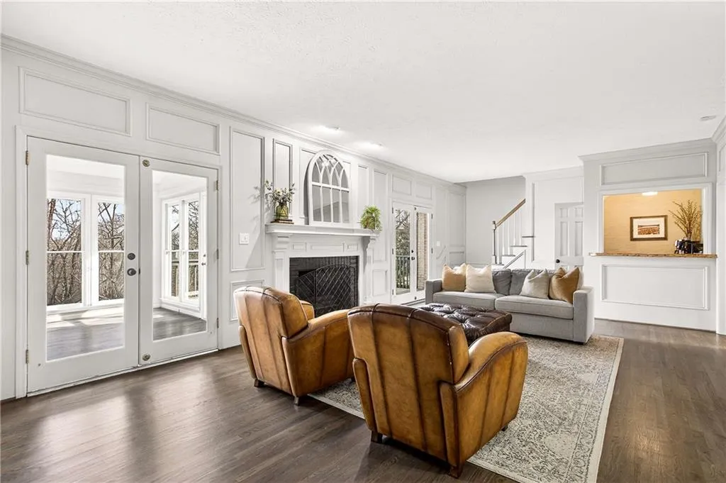 Fireside family room with tons of space for all of your oversized furniture, entrance onto the light-filled sunroom and custom wet bar.