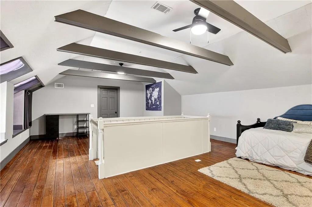 This third floor bonus room is unique to homes of this age - features reclaimed hardwood floors, beamed ceilings, a sink, walk-in closet and walk-in attic storage.