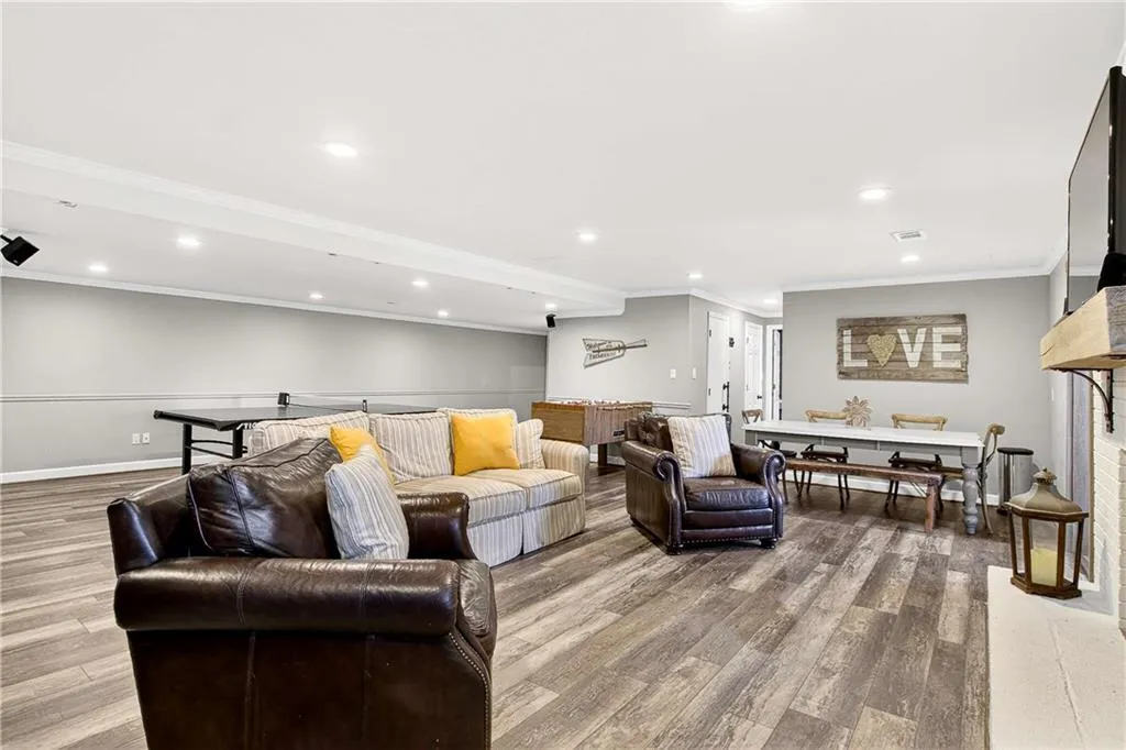 Huge open area with fireplace, new LVP flooring, new lighting and plenty of space for all of your furniture AND game tables!