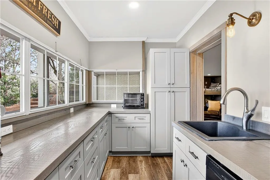 This basement kitchen is fully-equipped with everything you'd need to live autonomously PLUS has convenient windows that serve to the covered rear patio!
