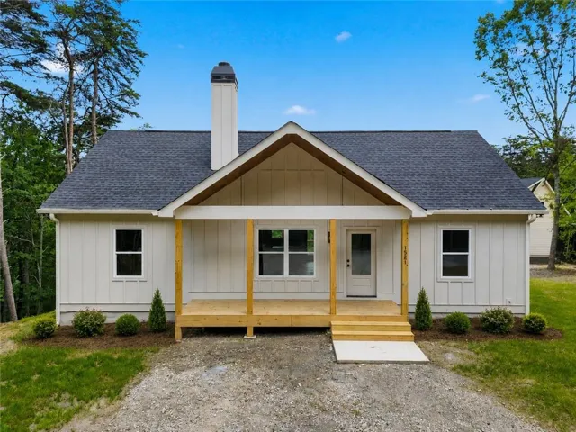 White vertical siding exterior with dark gray roofing