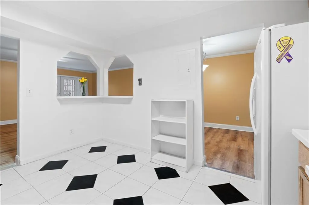 Bathroom featuring wood-type flooring, crown molding, and electric panel