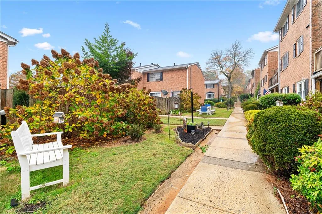 View of home's community with a lawn