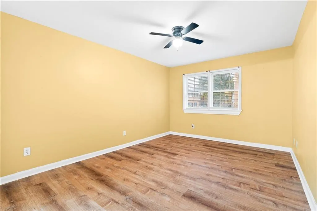Spare room with ceiling fan and wood-type flooring