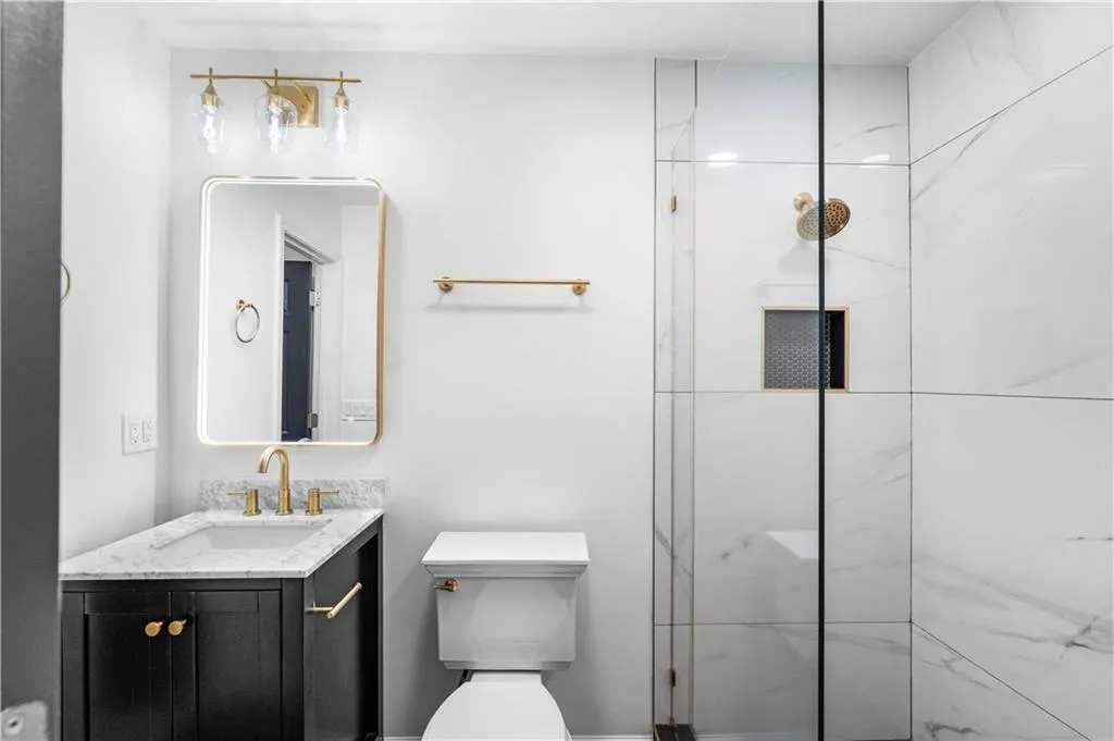 The 3rd bedroom's en suite features a beautiful, spa-like walk in shower.