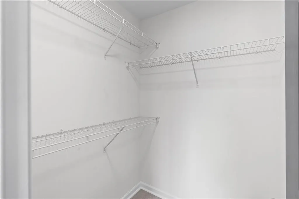 Built-in wire shelving system with multiple tiers in the walk-in closet.
