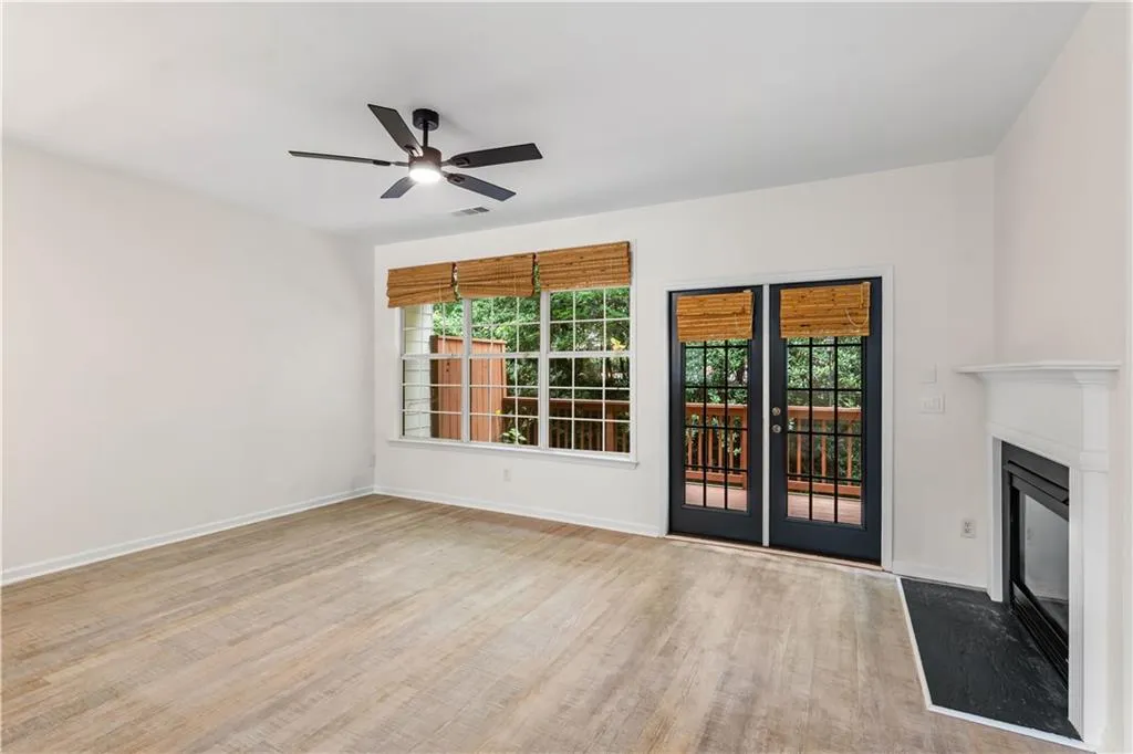 The spacious living room has tons of light and direct access to the outdoor deck.