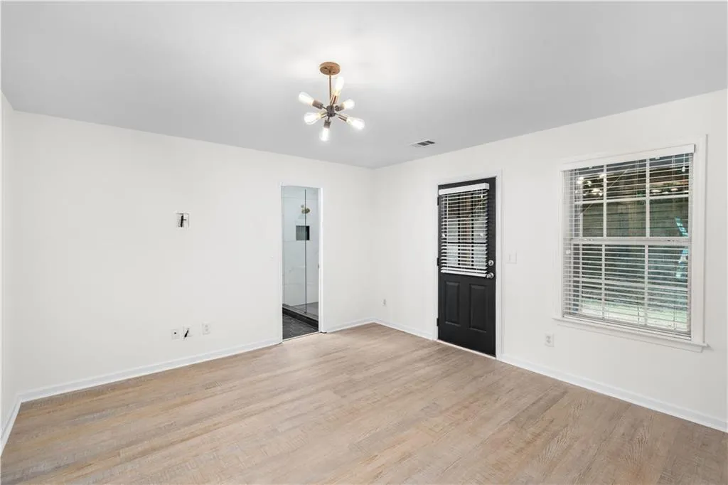 The third bedroom features a newly updated en suite and access to the back private patio.