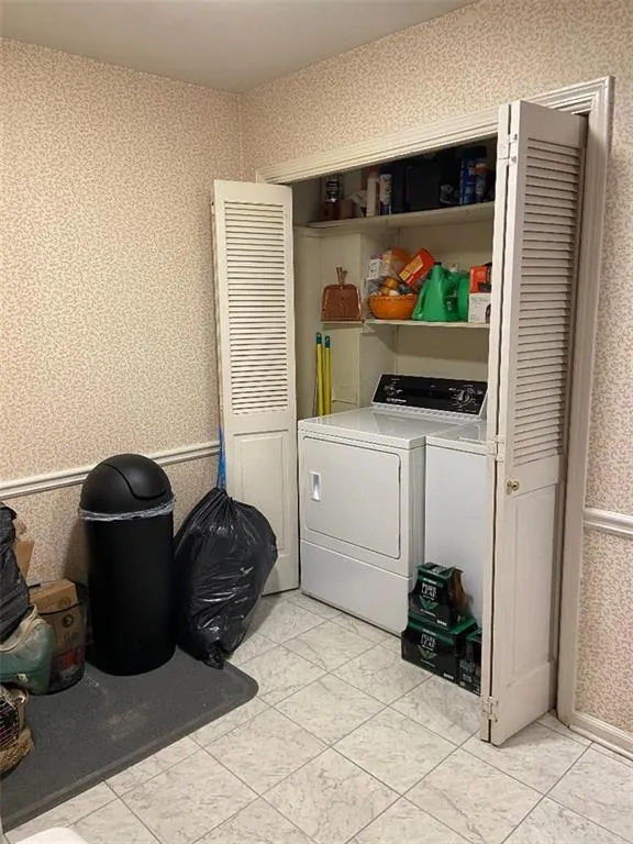 Washroom featuring washing machine and clothes dryer
