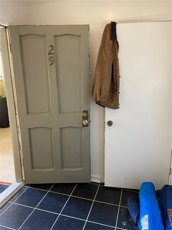 Doorway to outside featuring tile patterned flooring