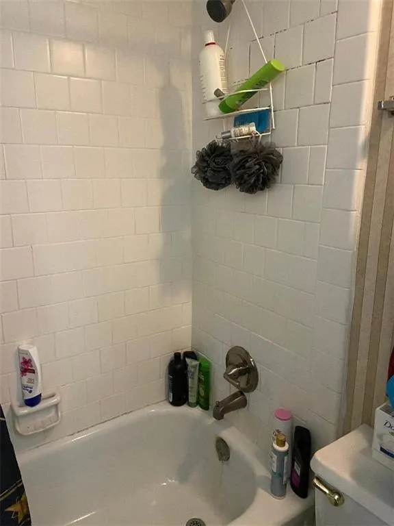 Bathroom with bathtub / shower combination and toilet