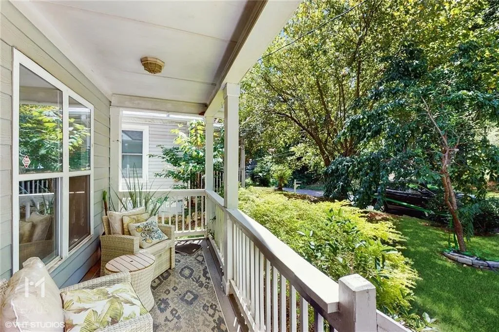 View of covered porch overlooking fragrant bush garden (olive tea leaf & magnolia) and fertile peachtree