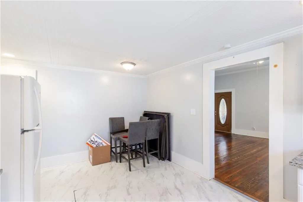 Home office with crown molding and light wood-type flooring