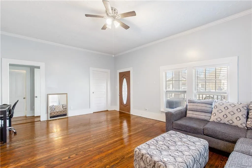 Living room with crown molding and dark hardwood / wood-style floors