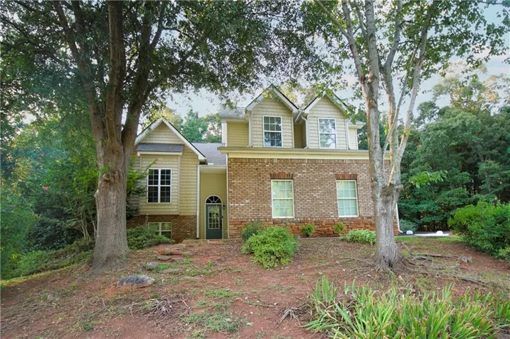 Brick and siding exterior with gabled roofline and dormer windows